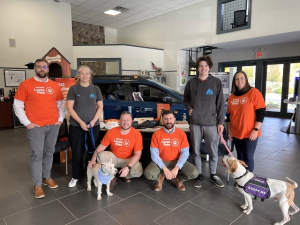 People in front of the Subaru supports pets display.