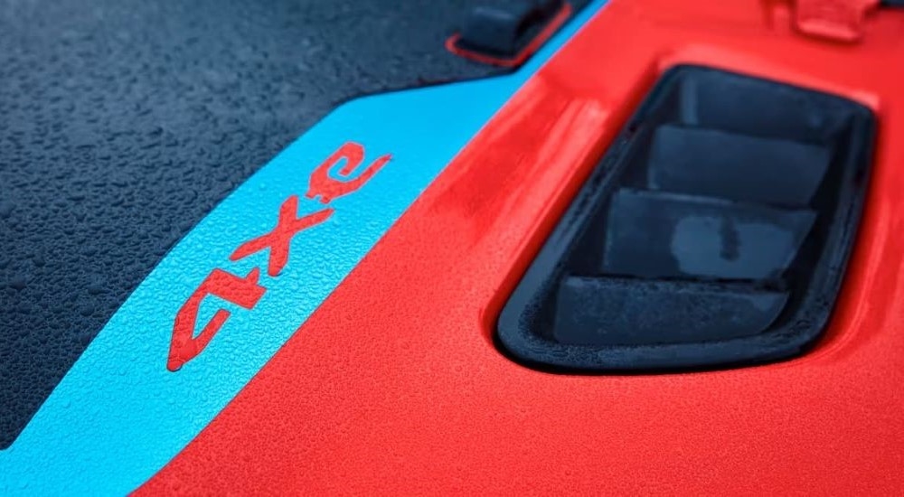 A close-up on the hood of a red 2024 Jeep Wrangler 4xe