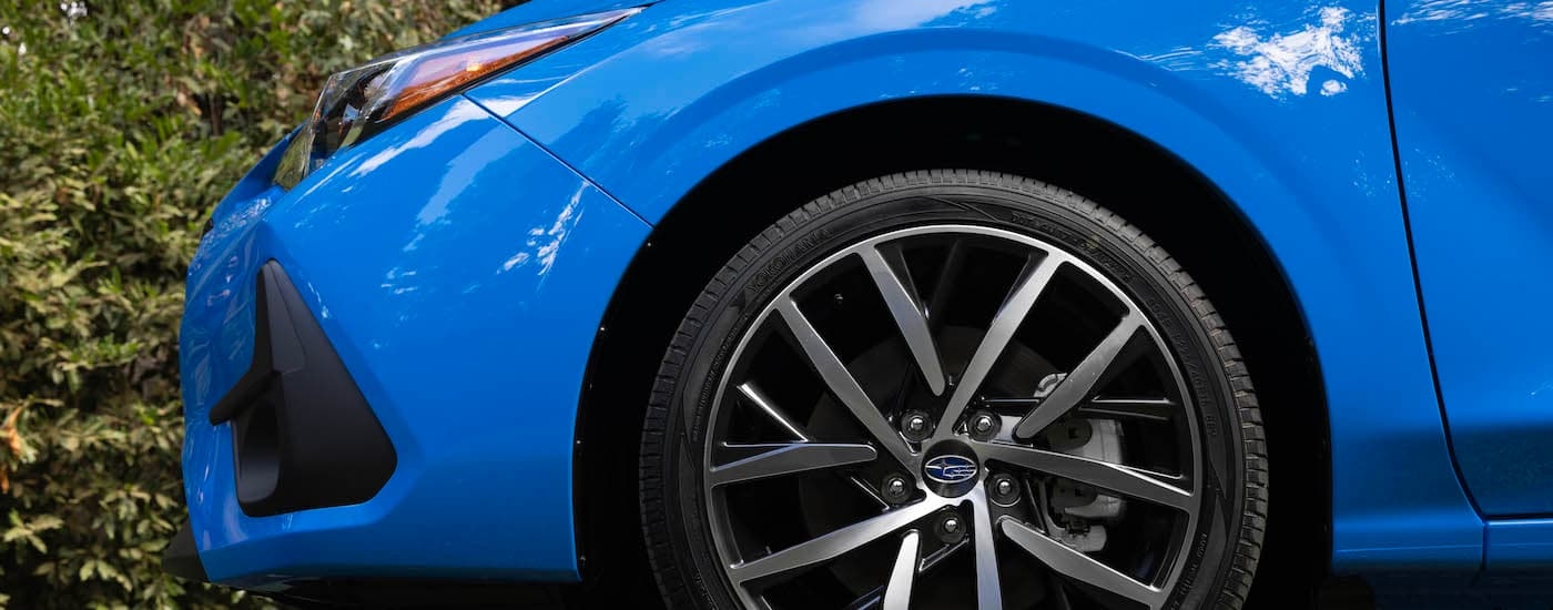 Side angle close-up on the hood of a blue 2024 Subaru Impreza for sale in Rhinebeck.