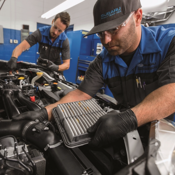 Subaru service technician performing maintenance