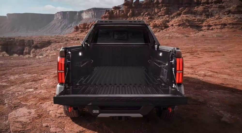 A rear view of a bed of a black 2024 Toyota Tacoma Trailhunter.