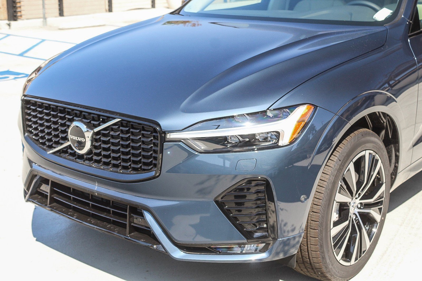 blue 2025 Volvo XC60 SUV parked at the Volvo Cars Mission Viejo dealership in Mission Viejo, CA