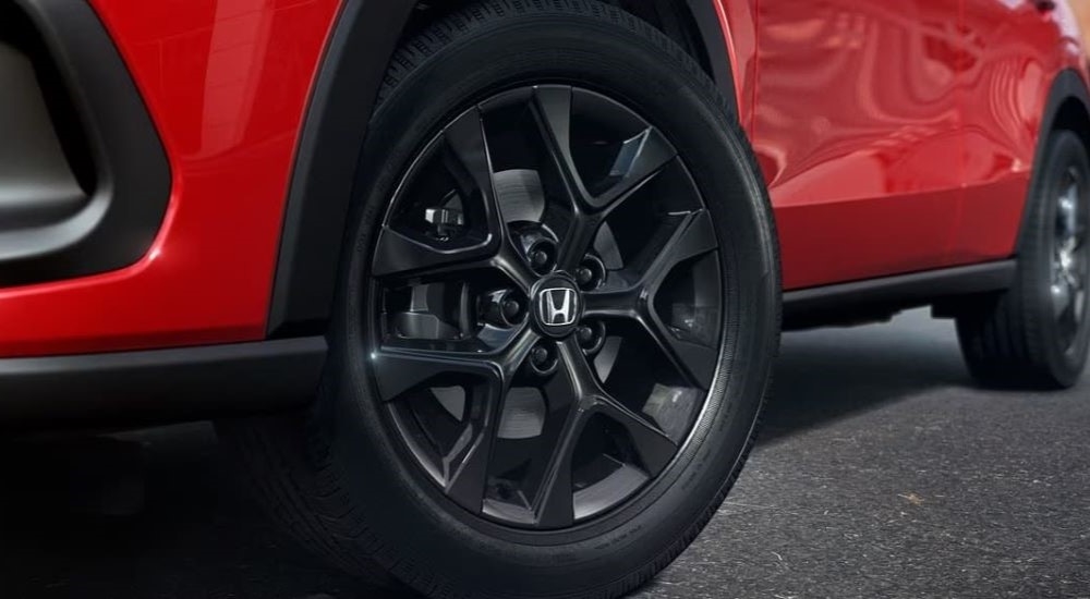 Close-up of the wheel on a red 2023 Honda HR-V Sport.