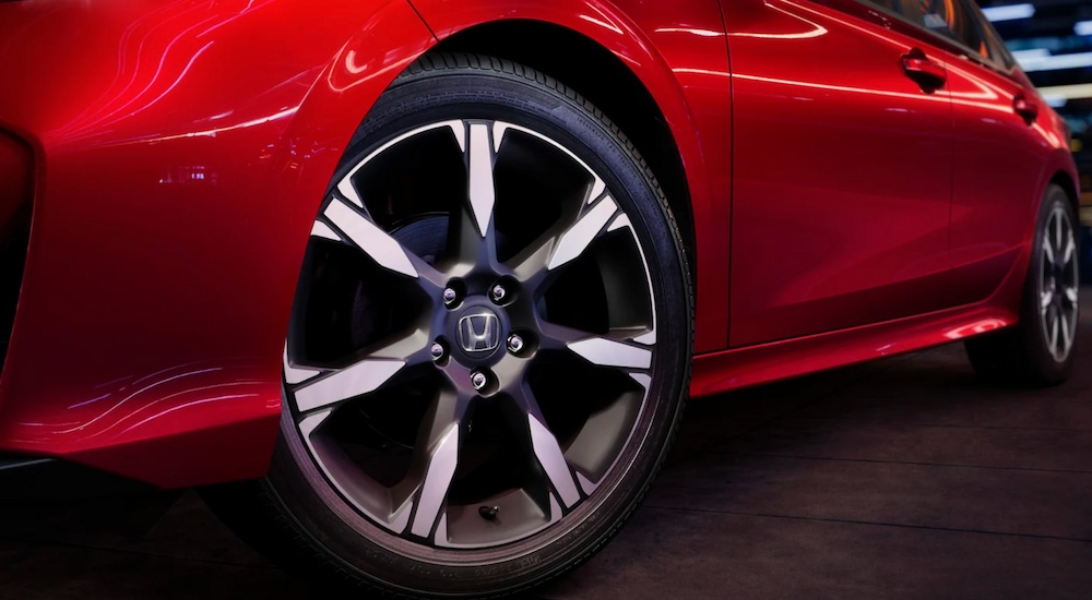 Close-up of the front wheel on a red 2025 Honda Civic Sedan.