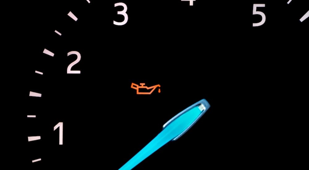 Close-up of the engine oil light on a car's dashboard.