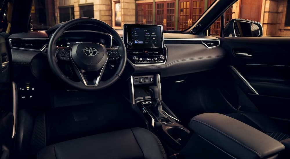 The black interior cabin of a 2024 Toyota Corolla Cross Hybrid.