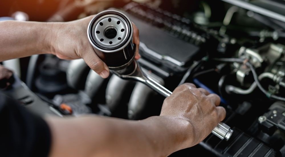 A tech is shown holding an oil filter.