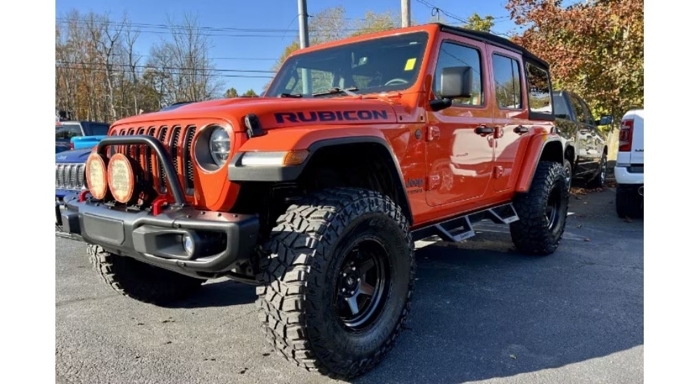 A red Jeep Wrangler Unlimted Rubicon is shown.