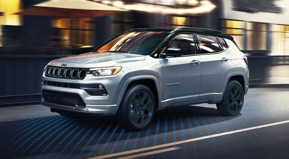 Simulated sensor lines are shown coming from a silver 2023 Jeep Compass.