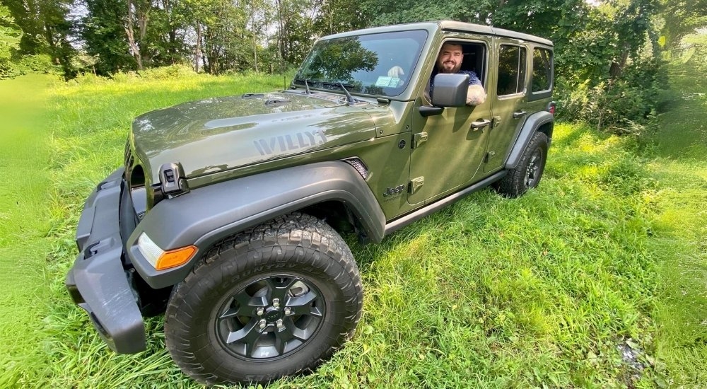 Rob Moore is shown in a green Jeep Wrangler Unlimited Willy's..