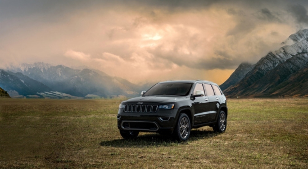 A black 2022 Jeep Grand Cherokee Limited is shown on a cloudy day.