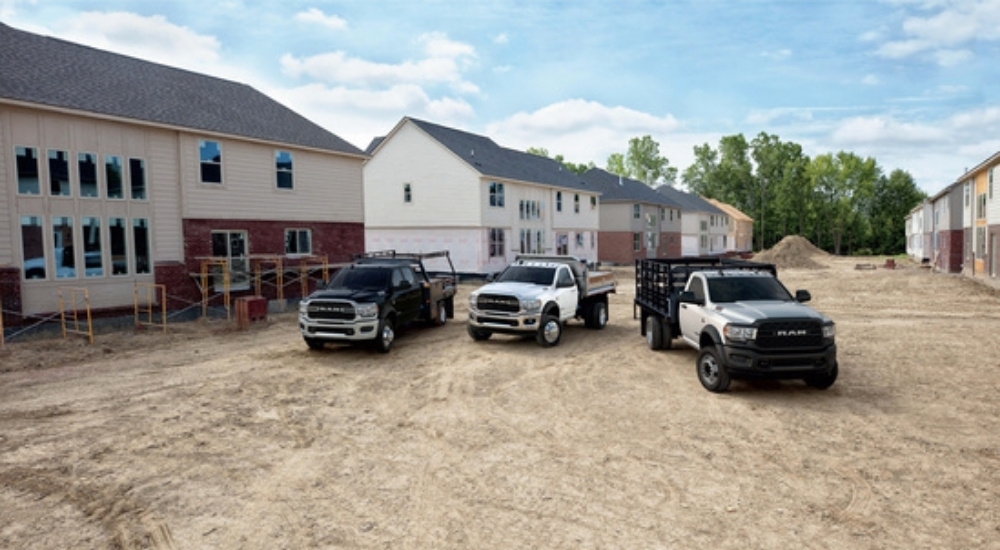 Three 2021 RAM commercial trucks are shown.