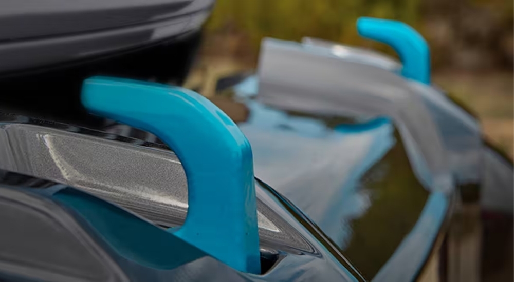 A close up shows blue hooks on a grey 2024 Jeep Wrangler 4xe.