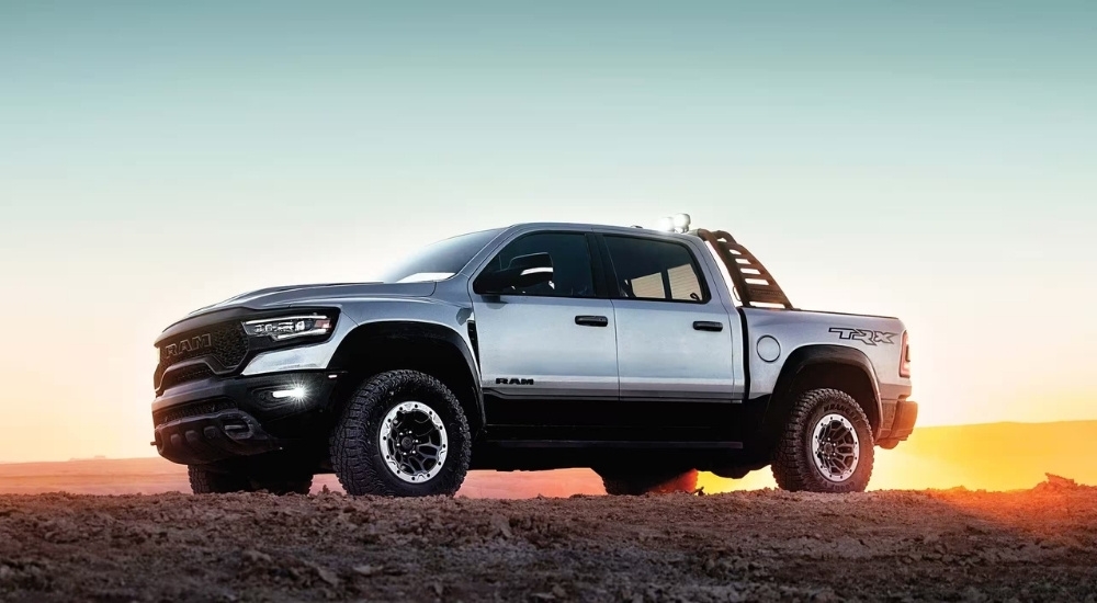 A silver 2023 Ram 1500 TRX is shown at sunset.