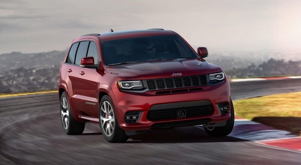 A maroon 2017 Jeep Grand Cherokee SRT is rounding the conrner on .