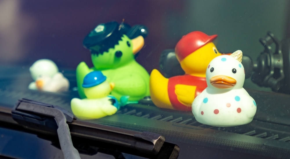 Rubber ducks are shown on a dashboard.