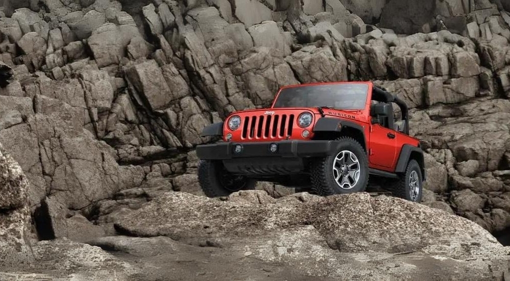 A red 2017 Jeep Wrangler Rubicon is shown off-road.