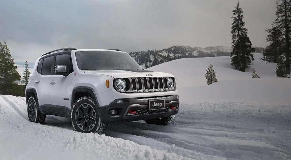 A white 2018 Jeep Renegade Trailhawk is shown on a snowy trail.