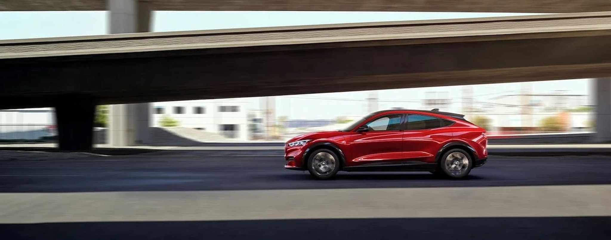 
A red 2022 Ford Mustang Mach-E is shown from the side.