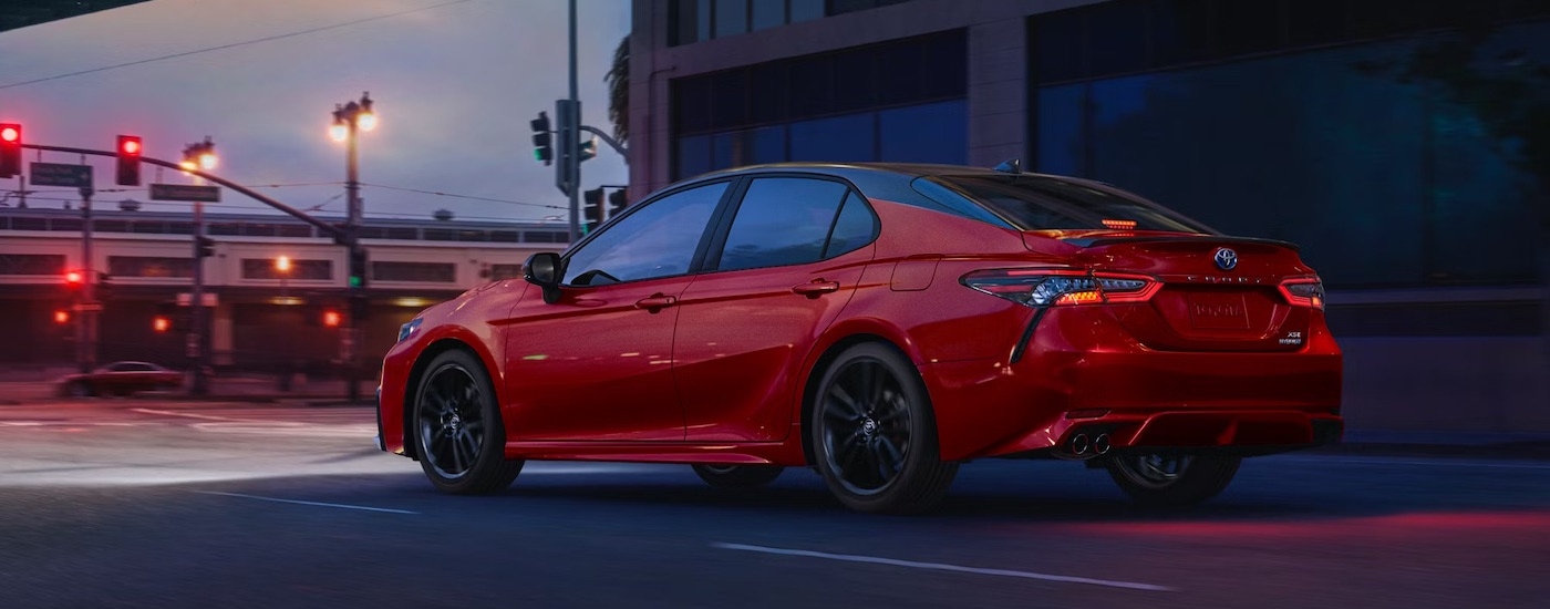 A red 2022 Toyota Camry is shown from th rear at an angle after leaving a used Toyota dealer.