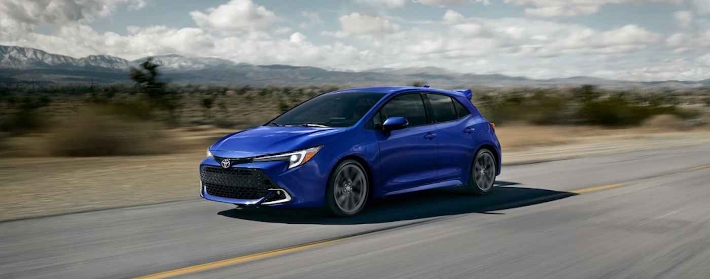 A blue 2023 Toyota Corolla Hatchback is shown from the front at an angle.