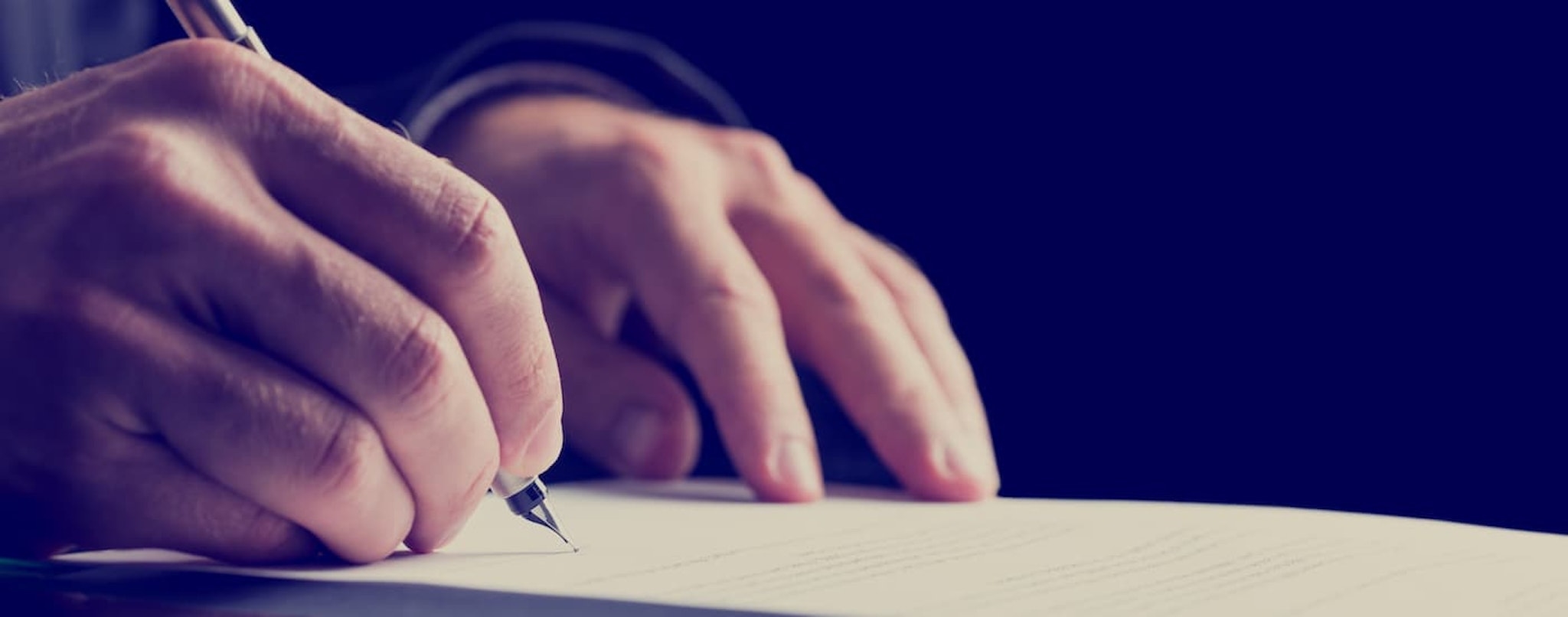 A close up shows someone signing a subprime auto loan near Claremont, NH.