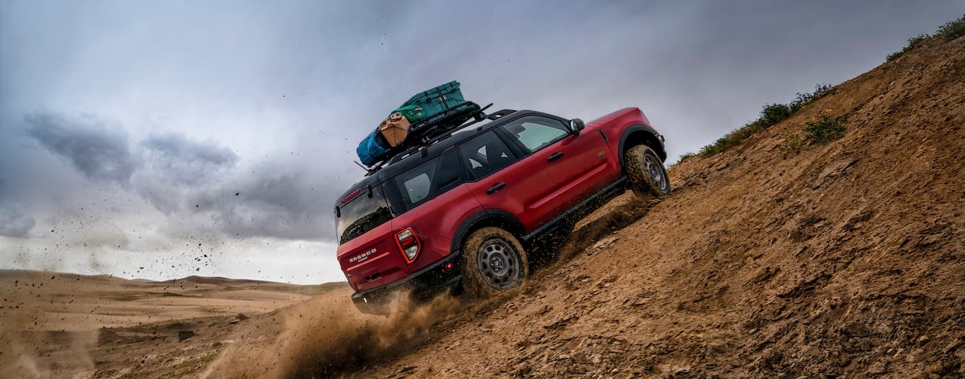 A red 2022 Ford Bronco Sport is shown from the rear at angle while off-road.