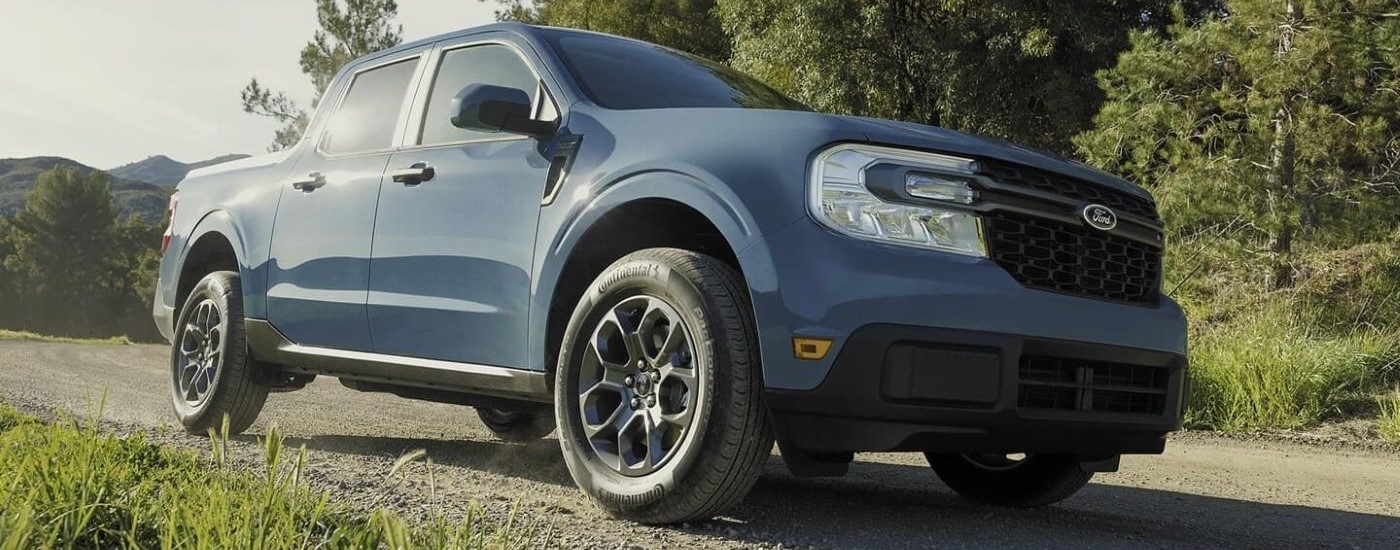 A blue 2024 Ford Maverick XLT is shown parked on a tail.