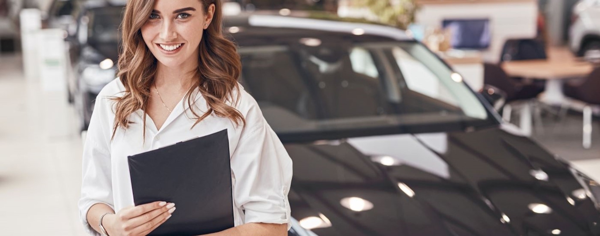 A salesperson is shown at a dealership providing bad credit car loans near Springfield, VT.