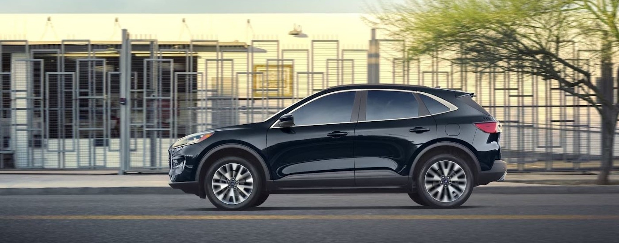 A black 2022 Ford Escape is shown from the side on a city street.