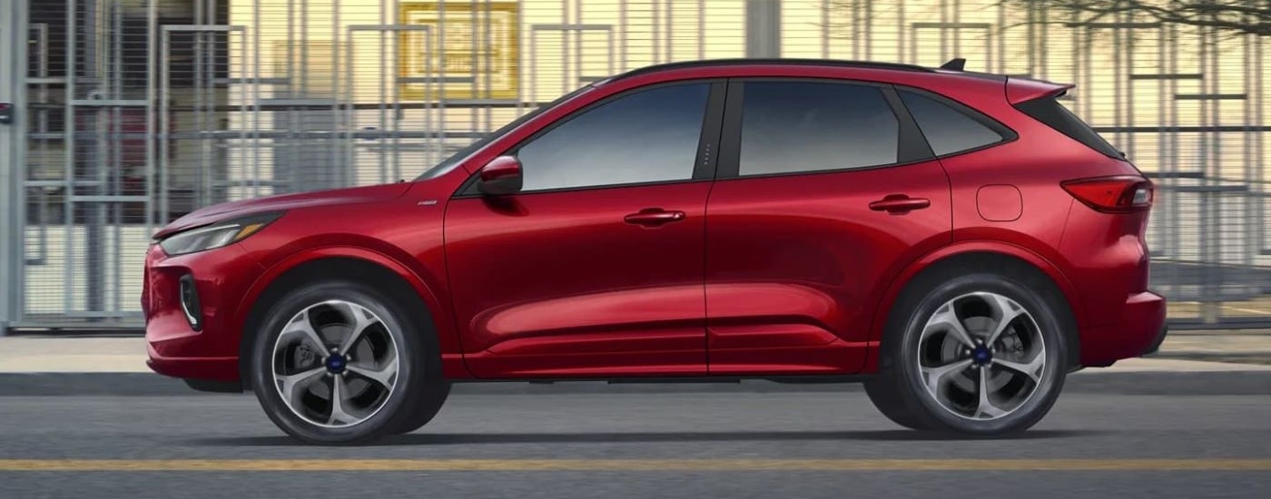 A red 2024 Ford Escape ST-Line is shown from the side.