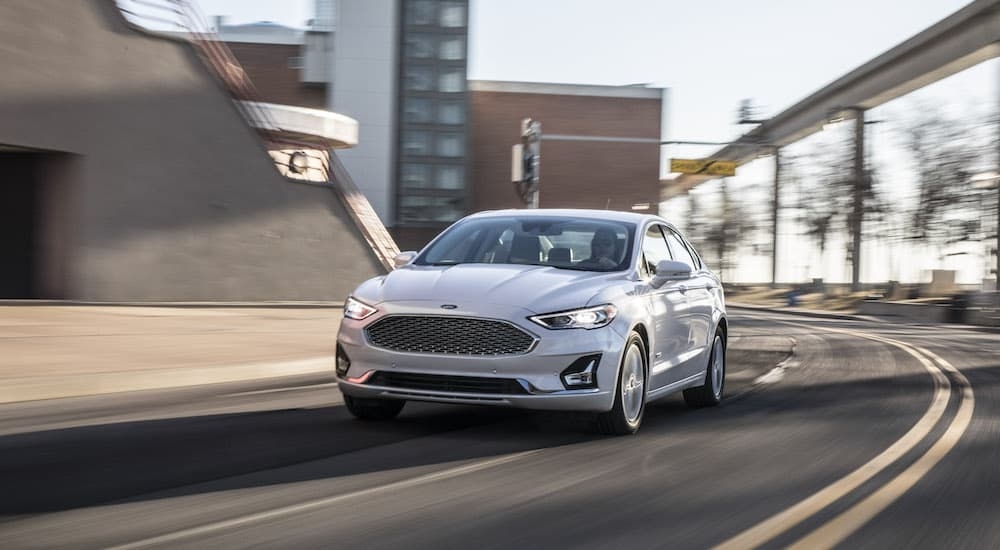 A white 2020 Ford Fusion is shown from the front at an angle after leaving a dealer that has used Ford for sale.