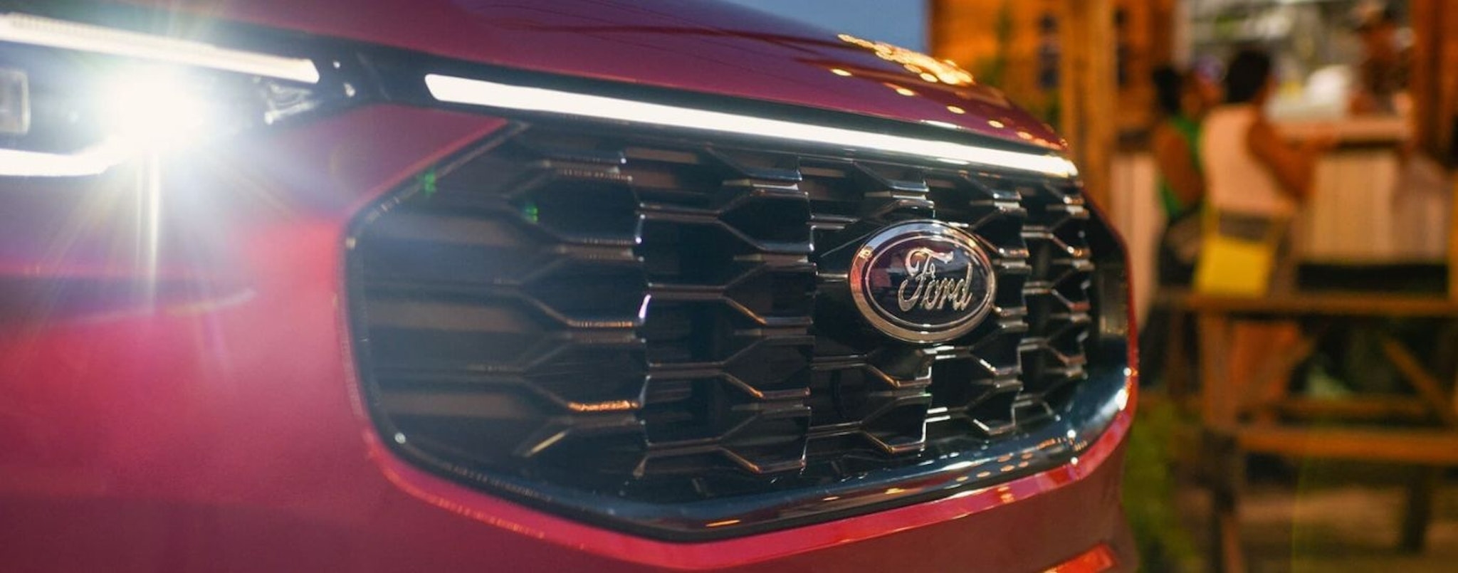 A close up shows the grille on a red 2025 Ford Escape.