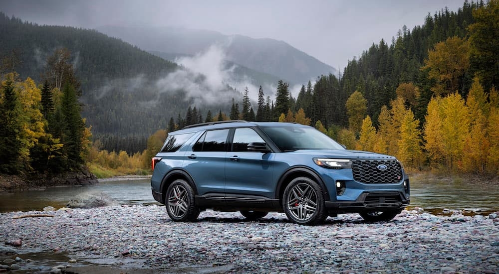 A blue 2025 Ford Explorer ST is shown from the side while off-road after leaving a Ford dealer near Chesterfield.