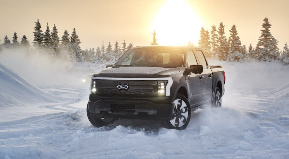 A black 2022 Ford F-150 Lightning is shown from the front at an angle after leaving a Ford EV dealer.