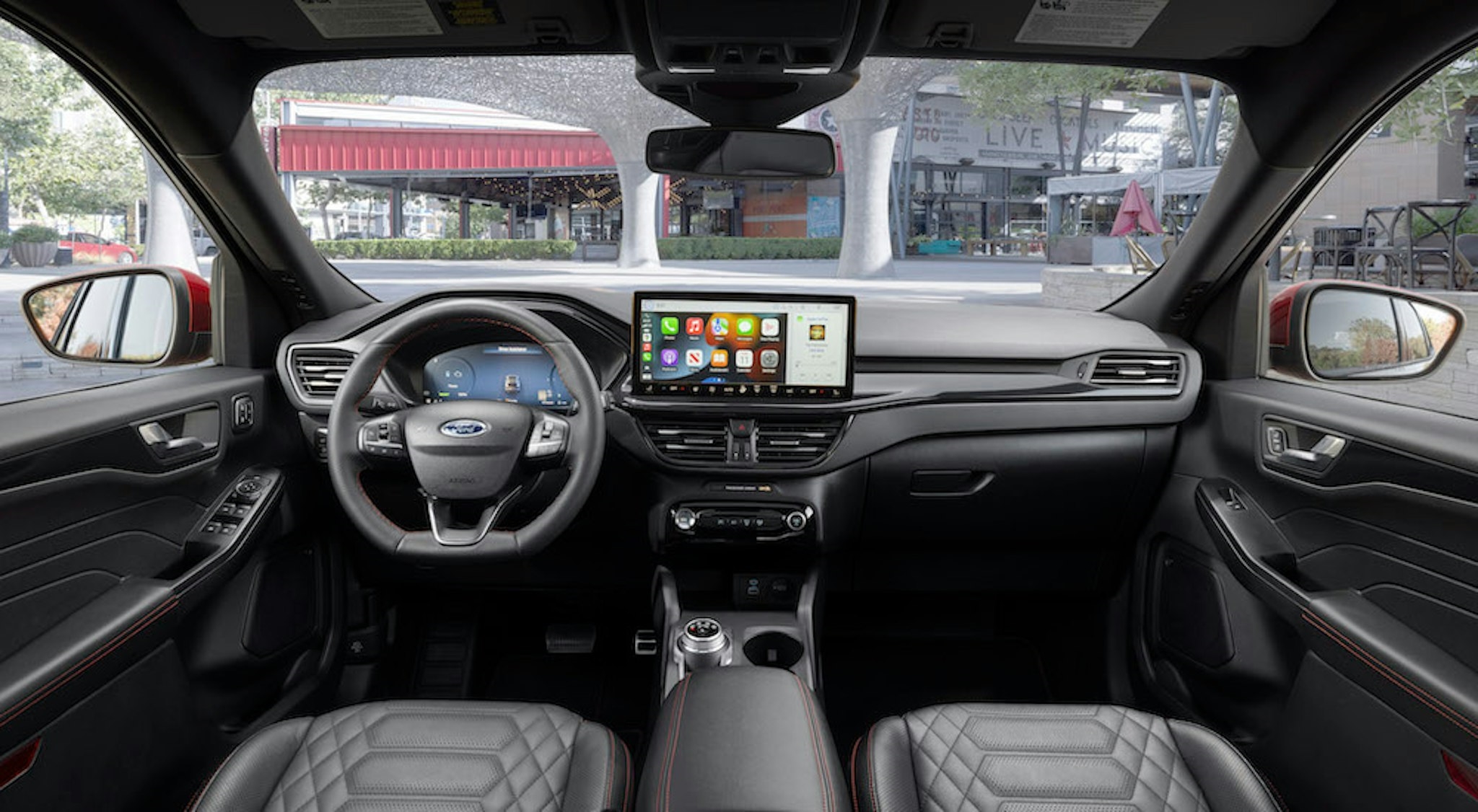 The black interior of a 2025 Ford Escape ST-Line is shown from above the center console.