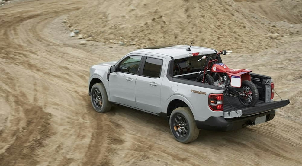 A white 2023 Ford Maverick Tremor is shown from the rear at a high angle.