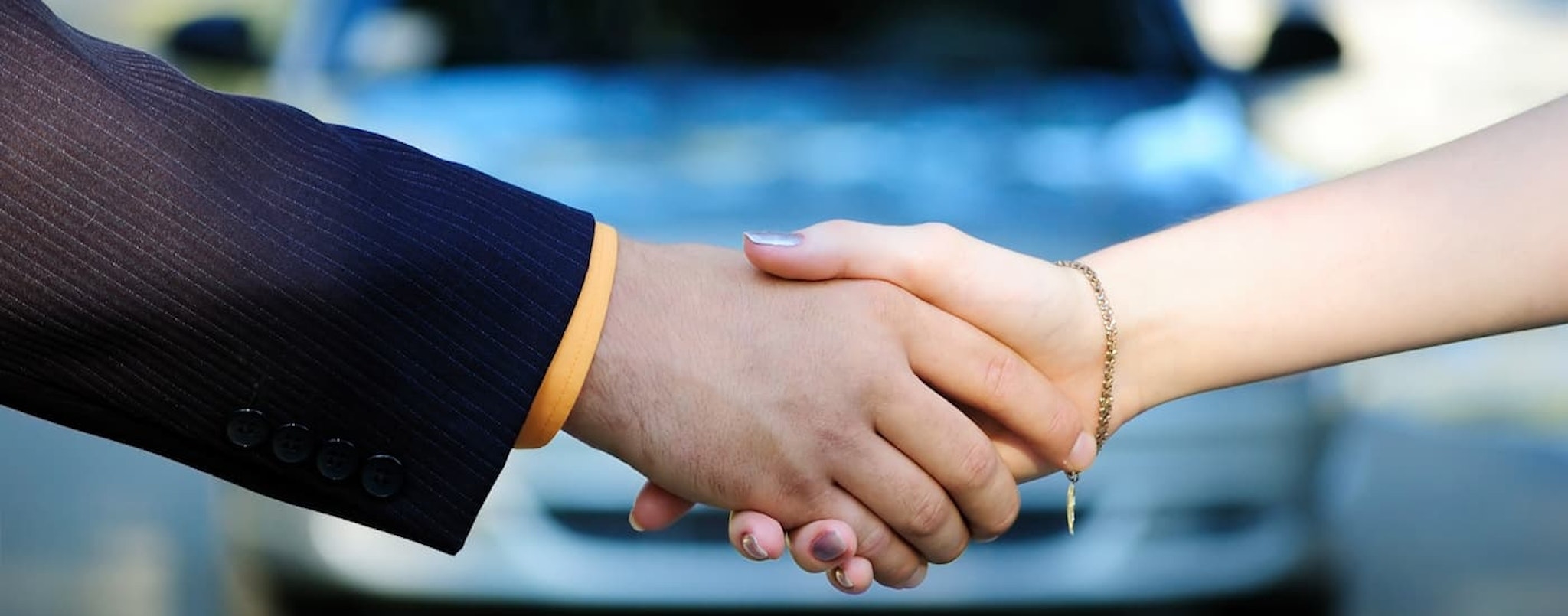 A salesman and customer are shown shaking hands after speaking about bad credit car loans near Lebanon, NH.