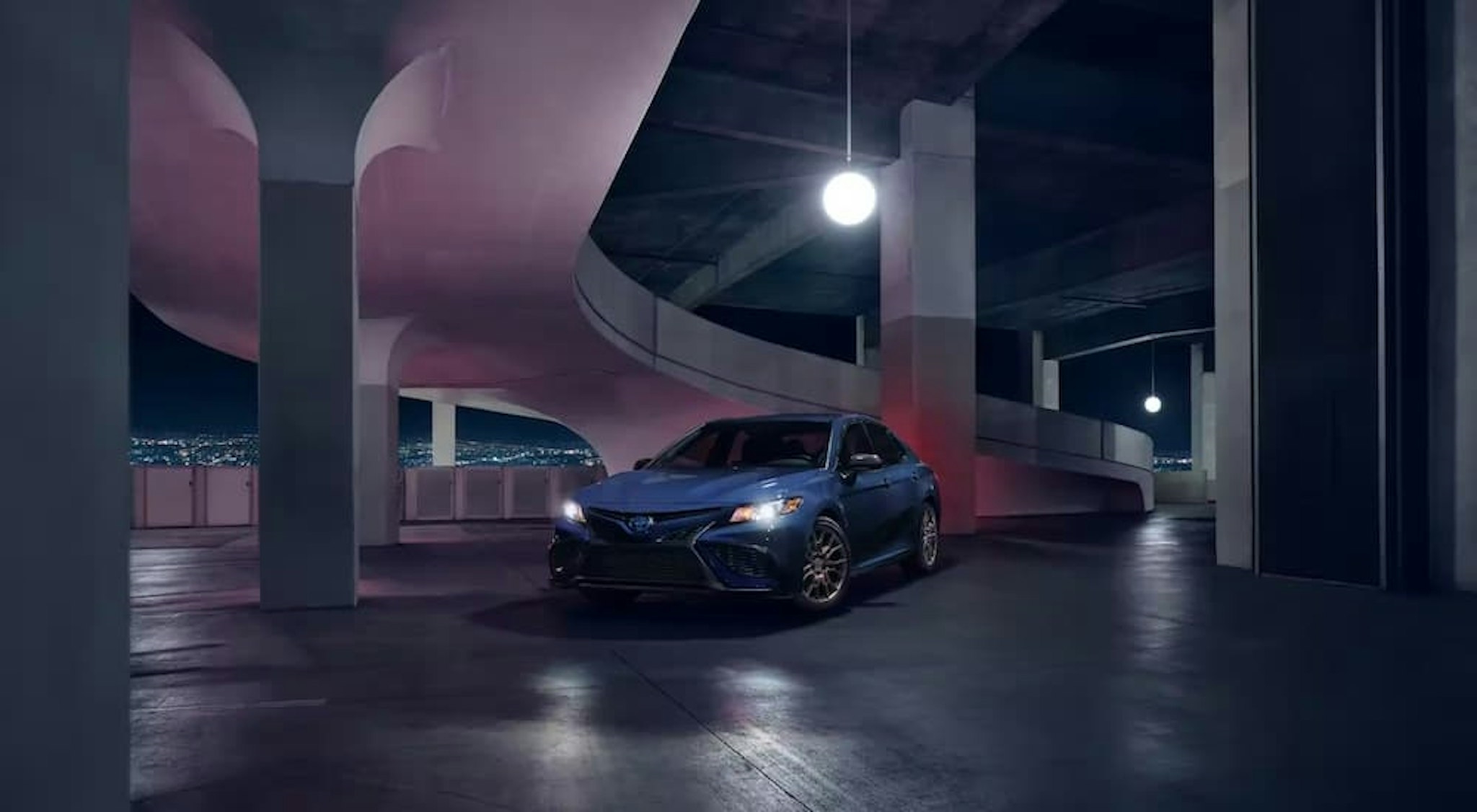 A blue 2023 Toyota Camry Nightshade is shown from the front at an angle.