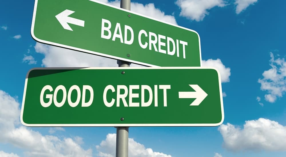 Two green signs that say 'good credit' and 'bad credit' are shown.