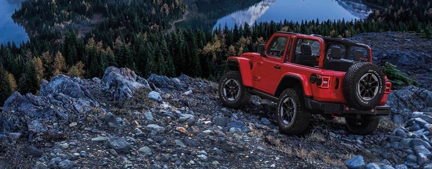 A red 2020 Jeep Wrangler is shown parked near a cliff.