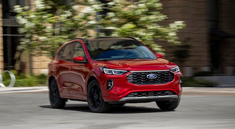 A red 2023 Ford Escape St is shown from the front at an angle during a short-term car rental.