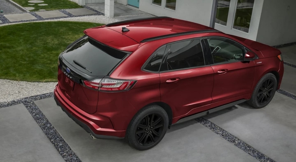 A red 2023 Ford Edge ST-Line is shown parked on a concrete driveway.