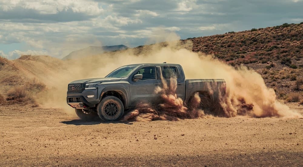 A silver 2022 Nissan Frontier Pro-4x is shown from the side while off-road.