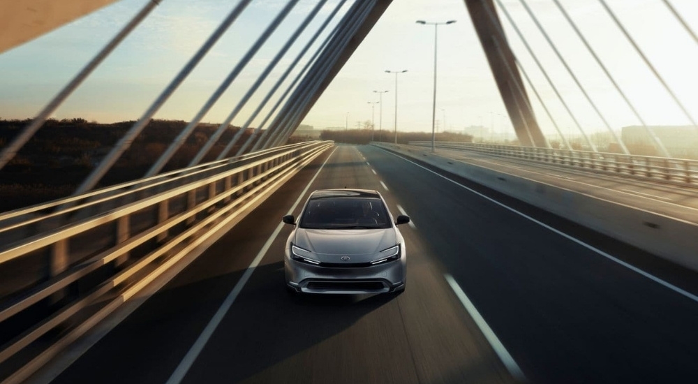 A silver 2024 Toyota Prius driving to a Toyota dealer near Keene.