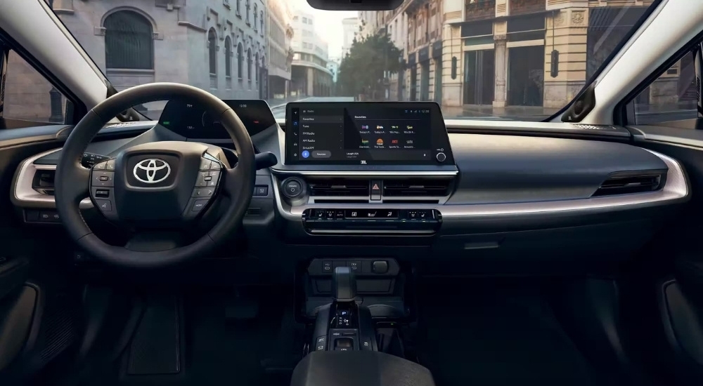 The black interior of a 2024 Toyota Prius is shown from above the center console.