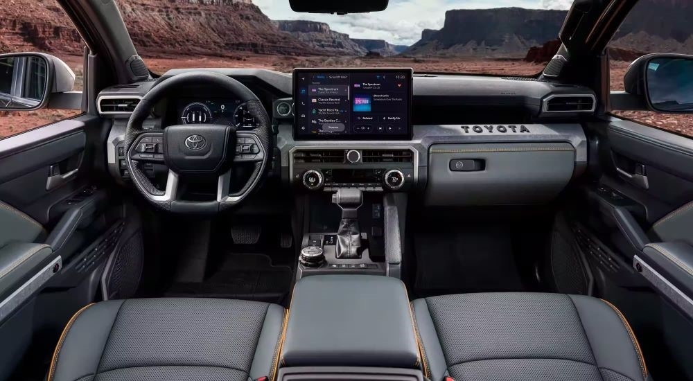 The black and grey interior in a 2024 Toyota Tacoma for sale.