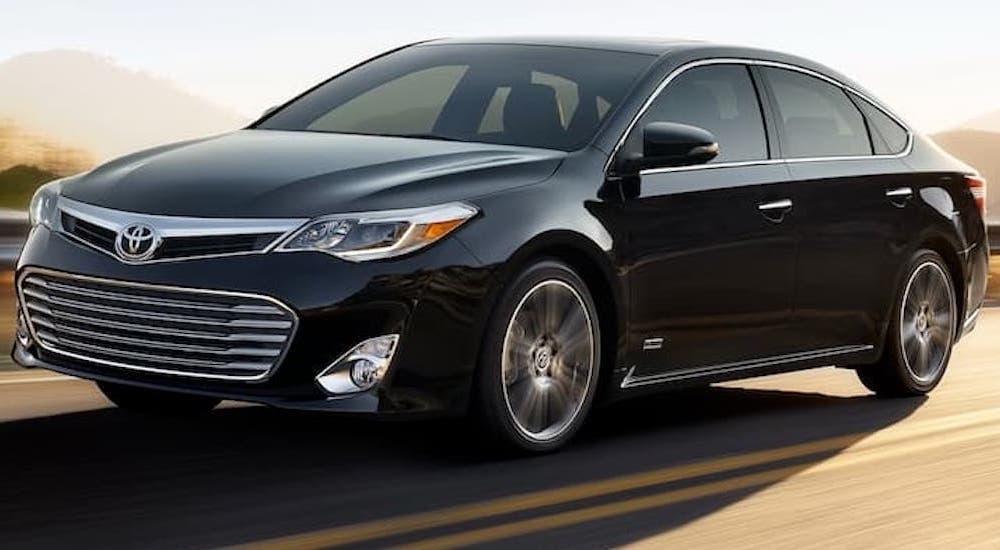 A black 2017 Toyota Avalon driving on a highway.