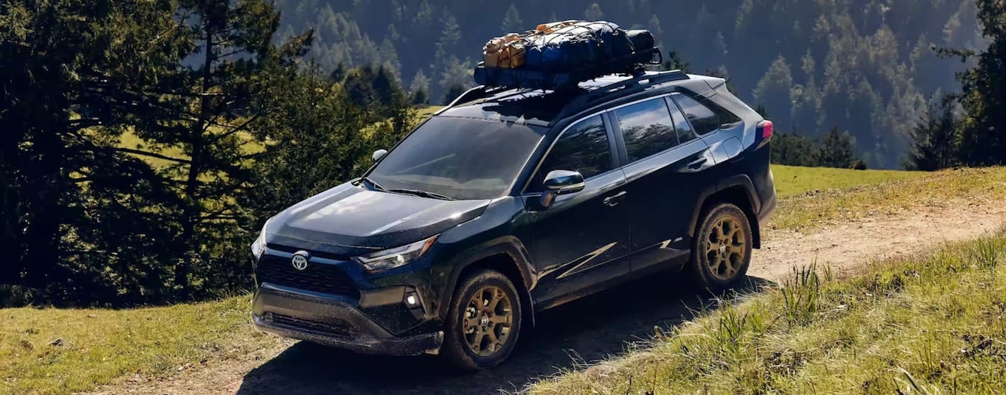 A black 2023 Toyota RAV4 TRD is shown off-roading after leaving a Toyota dealer in Westminster, VT.