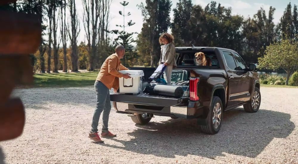 A brown 2022 Toyota Tundra is shown from the rear at an angle after leaving a dealer that has Toyota trucks for sale.